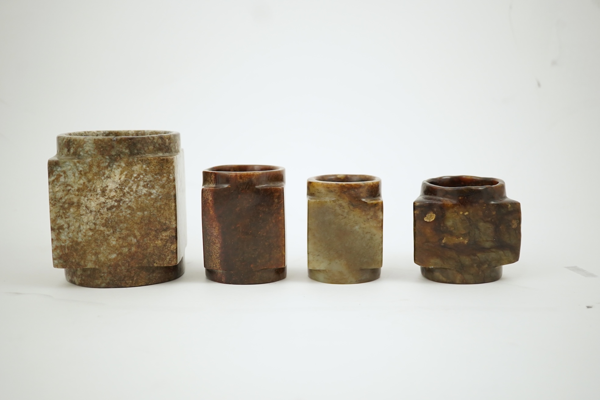 Four Chinese archaistic jade or hardstone cong